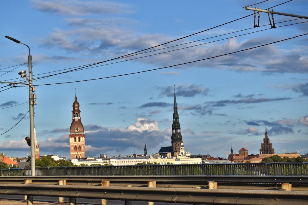 view of old riga church towers and the panorama tower from a bridge